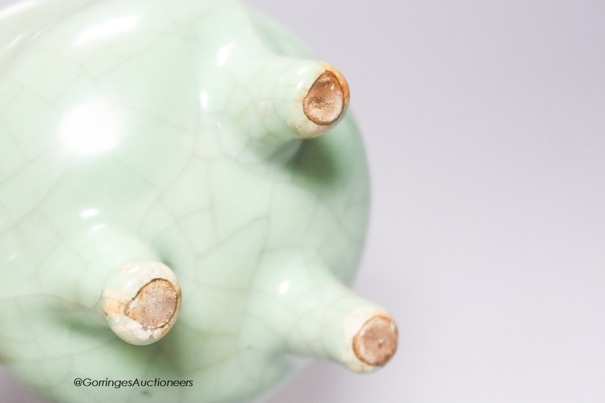 A Chinese green crackle glazed tripod censer, height 12cm